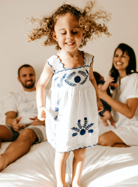 Little Girl jumping in the bed